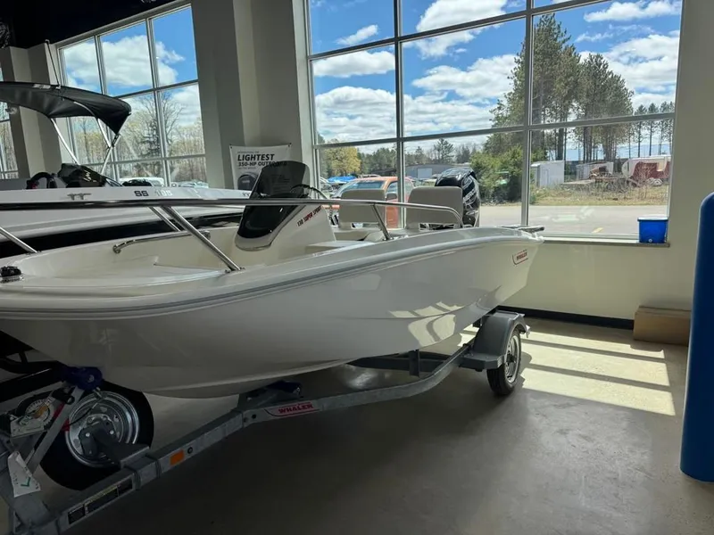 Slide: The Image of 2026 Boston Whaler 130 Super Sport in showroom. - 5