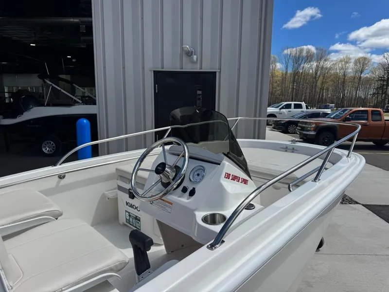Slide: The Image of 2026 Boston Whaler 130 Super Sport boat outdoors. - 7