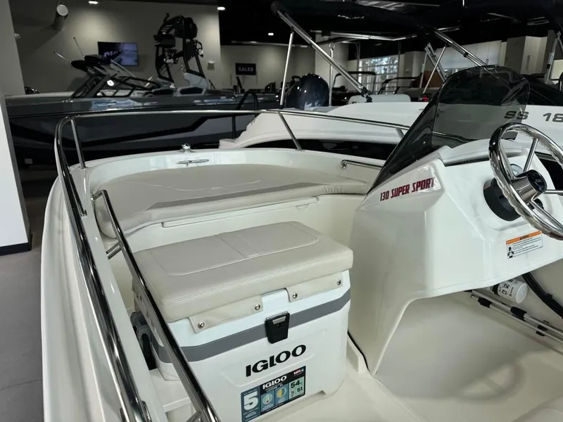 Slide: The Image of 2026 Boston Whaler 130 Super Sport boat with Igloo cooler. - 8