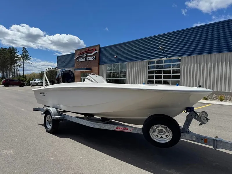 Slide: The Image of 2026 Boston Whaler 160 Super Sport in front of a boathouse. - 4