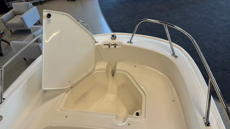 Slide: The Image of Boston Whaler 160 Super Sport 2026, open storage compartment in bow area. - 7