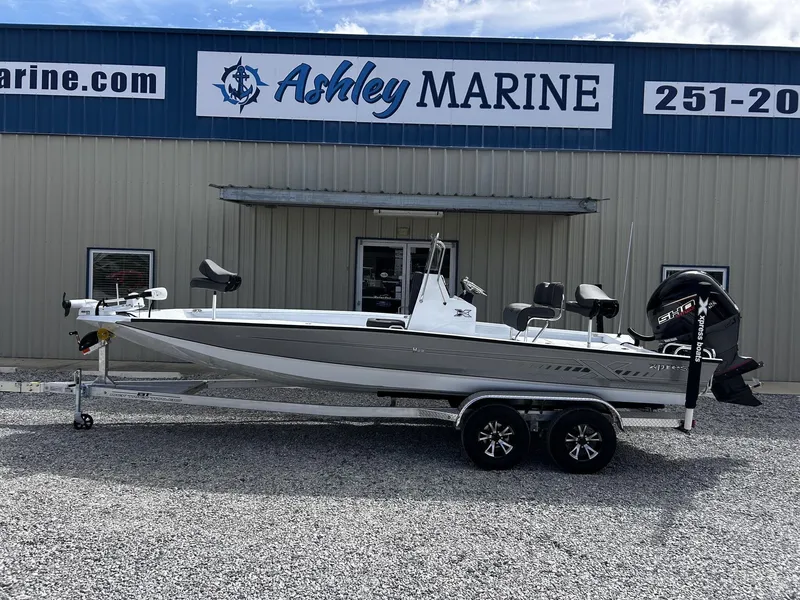 Slide: The Image of 2026 Xpress H22B Bay boat in front of Ashley Marine building. - 1