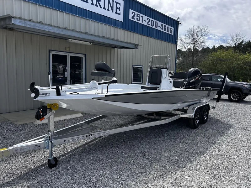 Slide: The Image of 2026 Xpress H22B Bay boat on trailer outside a building. - 2