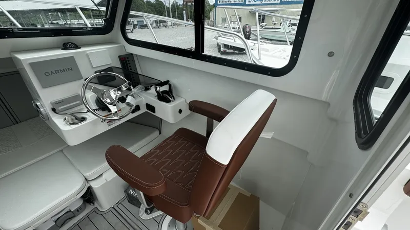 Slide: The Image of Interior of 2026 Parker 247 Explorer with helm console and seat. - 2