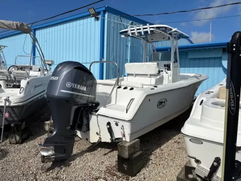Slide: The Image of 2016 Sea Hunt 234 Ultra boat with Yamaha engine, parked on gravel lot. - 3
