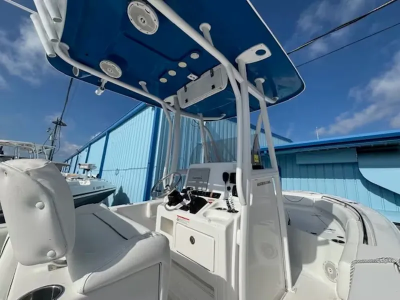 Slide: The Image of 2016 Sea Hunt 234 Ultra boat with blue canopy at dock. - 8