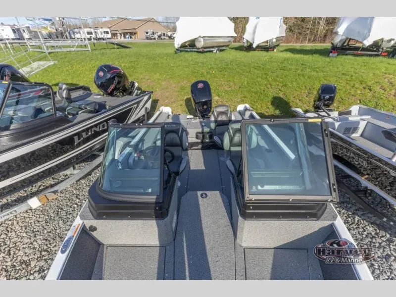 Slide: The Image of 2026 Adventure 1775 Sport boat displayed on gravel lot. - 5