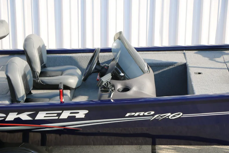 Slide: The Image of 2019 Tracker Pro 170 boat cockpit with seats and controls. - 10