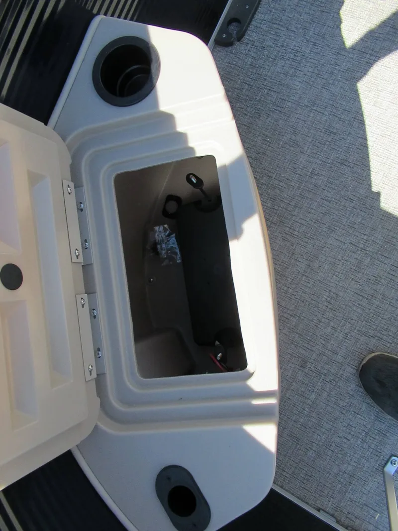 Slide: The Image of An open storage compartment on a boat with gray carpet flooring. - 8