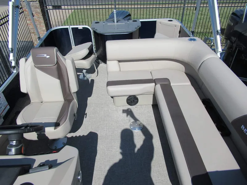 Slide: The Image of Interior of a Bennington 22 SF pontoon boat with beige and brown seating. - 3