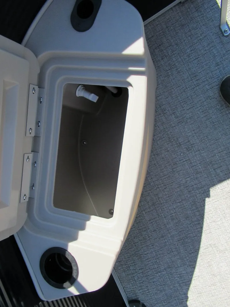 Slide: The Image of Open storage compartment on a boat with gray carpet flooring. - 7