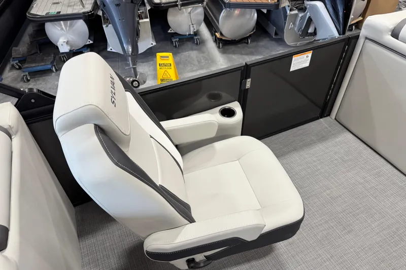 Slide: The Image of 2026 Sylvan Mirage X X5 boat interior with sleek white seating and cup holder. - 11