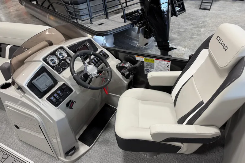 Slide: The Image of 2026 Sylvan Mirage X X5 boat interior with steering console and captain's chair. - 12