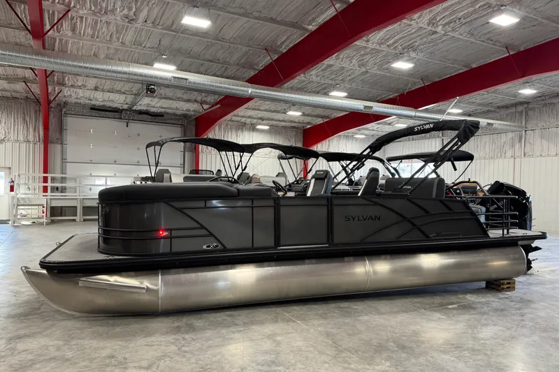 The Image of 2026 Sylvan X5 pontoon boat in a spacious indoor showroom. - 1