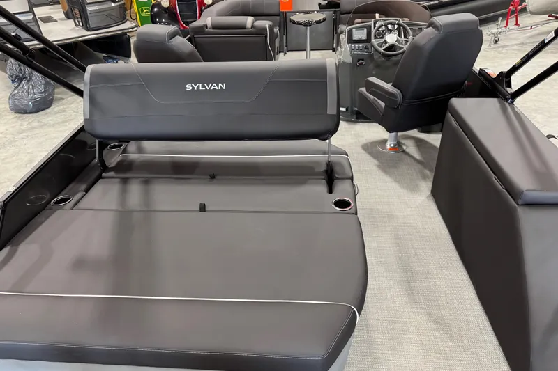 Slide: The Image of 2026 Sylvan X5 boat interior with sleek black seating and modern dashboard design. - 13