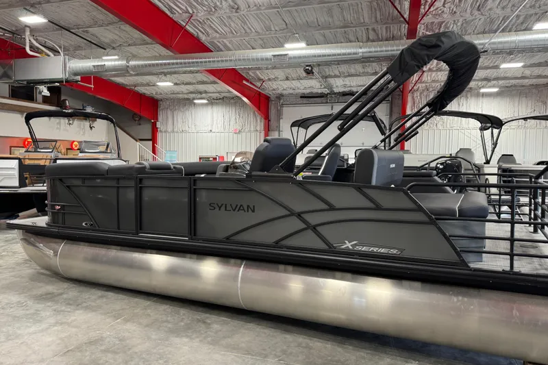 Slide: The Image of 2026 Sylvan X5 pontoon boat in showroom, featuring sleek design and modern seating. - 4