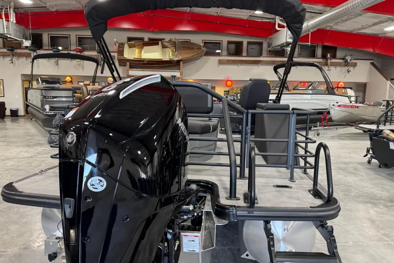 Slide: The Image of 2026 Sylvan X5 boat in showroom, featuring sleek black motor and modern design. - 6