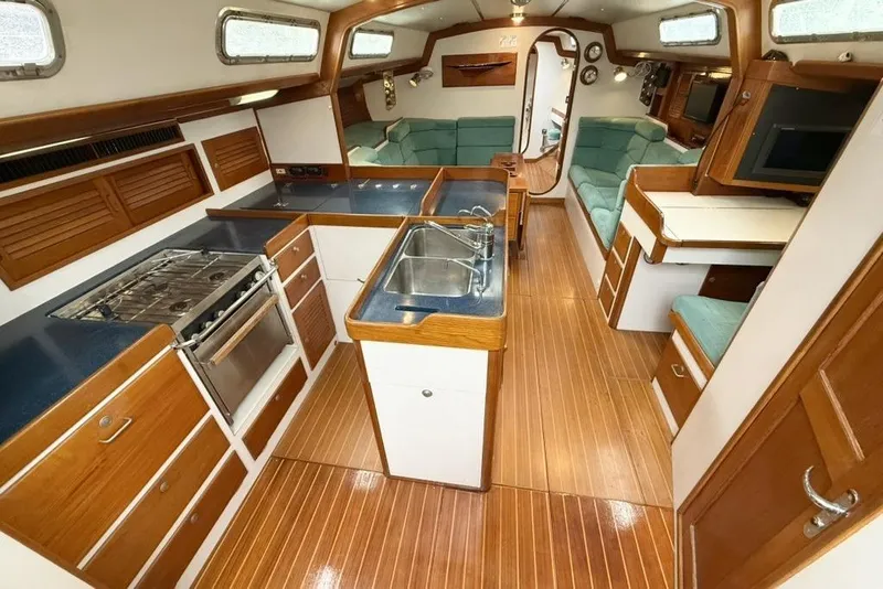 Slide: The Image of Luxurious 1996 J Boats J/160 yacht interior with wood finishes and modern amenities. - 1
