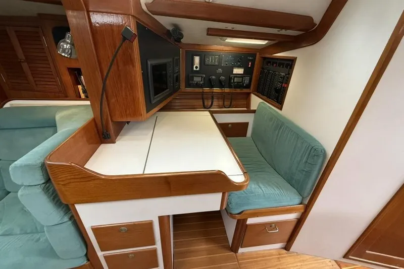 Slide: The Image of Interior of 1996 J Boats J/160 sailboat with navigation station and seating area. - 11