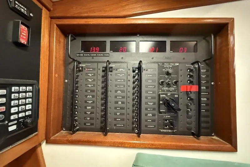 Slide: The Image of Electrical control panel on a 1996 J Boats J/160 yacht, featuring switches and digital displays. - 13
