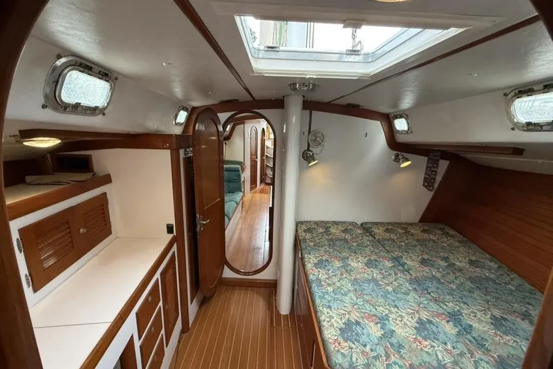 Slide: The Image of Interior of 1996 J Boats J/160 sailboat with cozy cabin and wooden finishes. - 15
