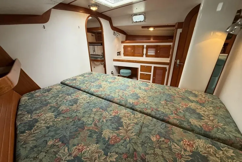 Slide: The Image of Cozy cabin interior of 1996 J Boats J/160 with floral bedding and wooden accents. - 17