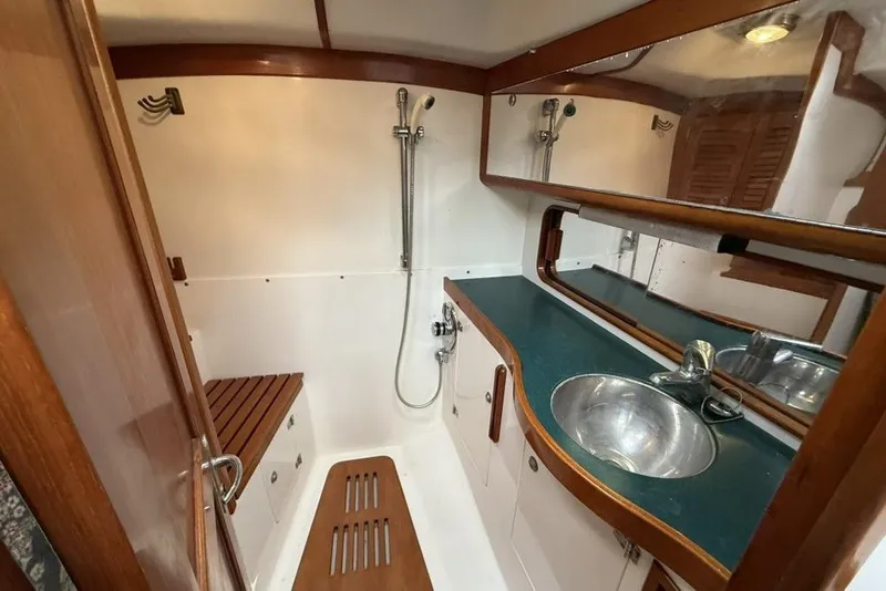 Slide: The Image of Luxurious bathroom interior of 1996 J Boats J/160 yacht with wooden accents and modern fixtures. - 19