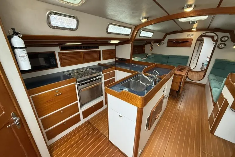Slide: The Image of Interior of 1996 J Boats J/160 yacht with kitchen and seating area. - 2