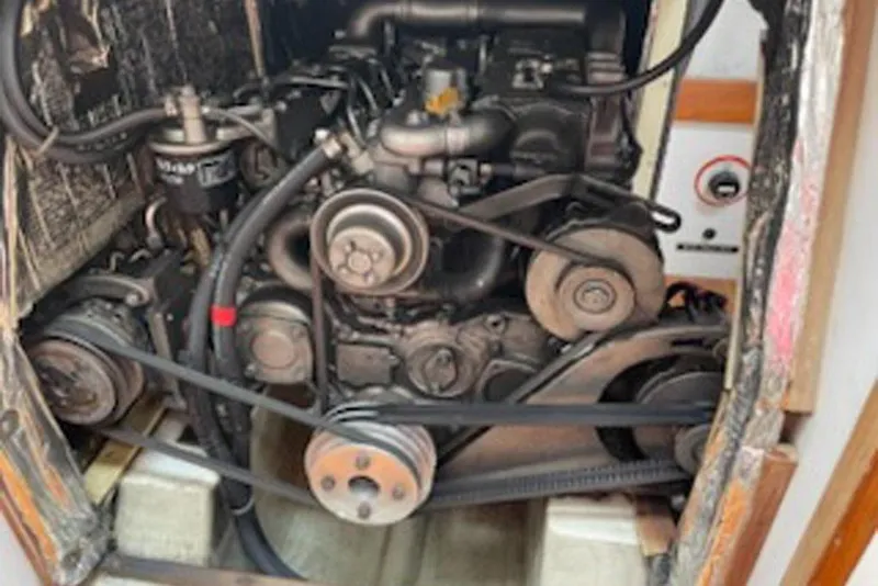 Slide: The Image of Engine compartment of a 1996 J Boats J/160 sailboat, showcasing mechanical components. - 24