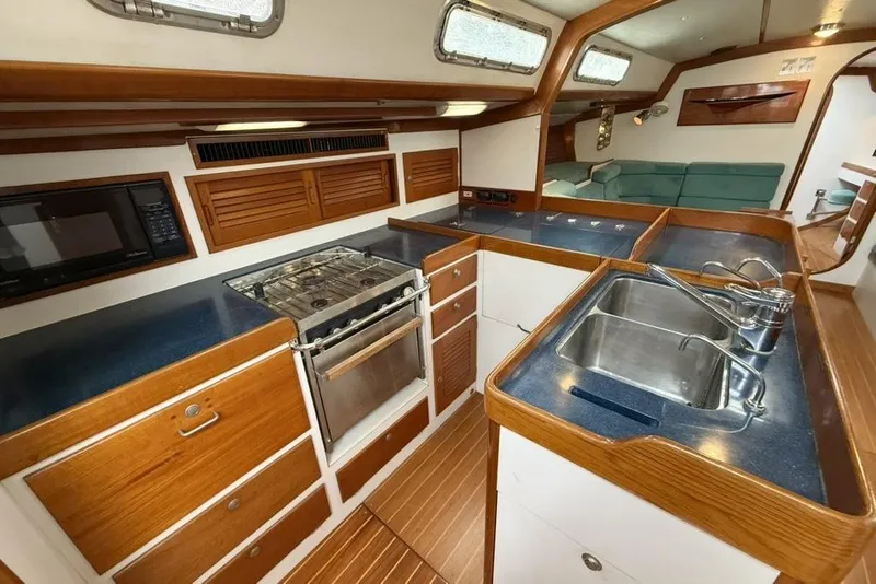 Slide: The Image of Luxurious 1996 J Boats J/160 yacht interior with modern kitchen and cozy seating area. - 3