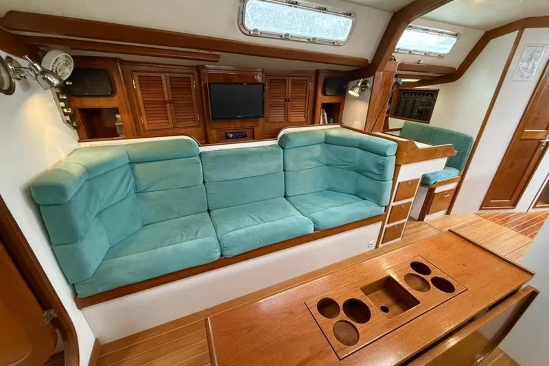 Slide: The Image of Luxurious interior of 1996 J Boats J/160 yacht with teal seating and wooden accents. - 6