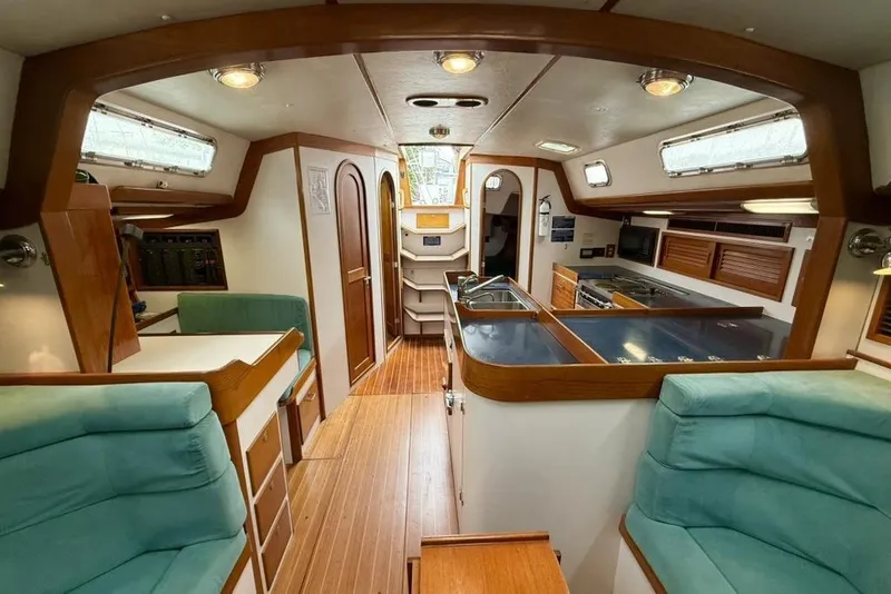 Slide: The Image of Luxurious interior of a 1996 J Boats J/160 sailboat with wood accents and modern amenities. - 8
