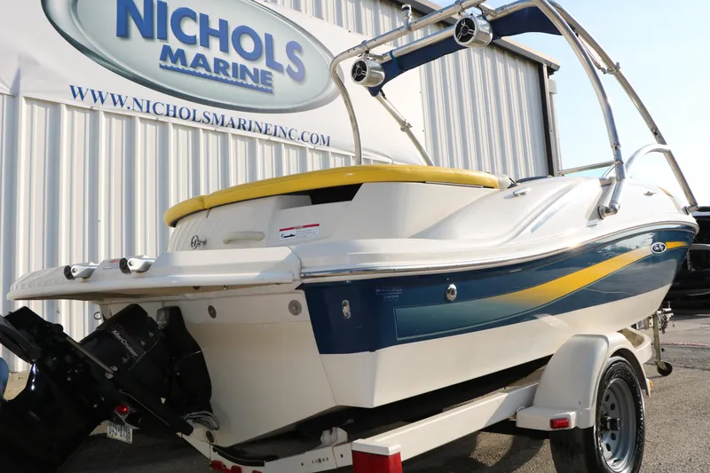 Slide: The Image of 2006 Sea Ray 185 Sport boat at Nichols Marine dealership, featuring sleek design and vibrant colors. - 19