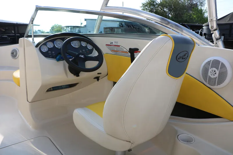 Slide: The Image of 2006 Sea Ray 185 Sport boat interior with steering wheel and dashboard controls. - 32