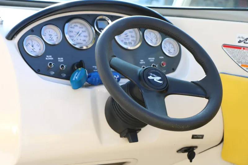Slide: The Image of Steering wheel and dashboard of a 2006 Sea Ray 185 Sport boat. - 37