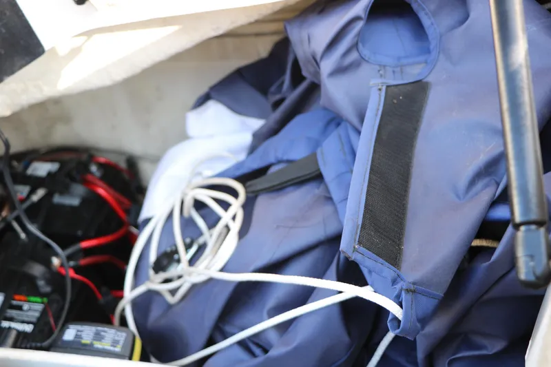 Slide: The Image of Storage compartment of a 2006 Sea Ray 185 Sport boat with life jackets and battery. - 46