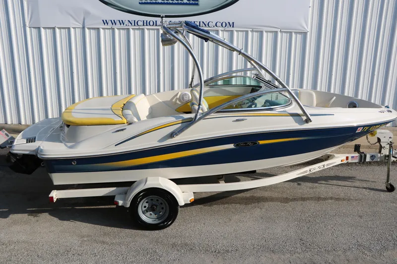 Slide: The Image of 2006 Sea Ray 185 Sport boat on trailer, featuring yellow and blue accents. - 8