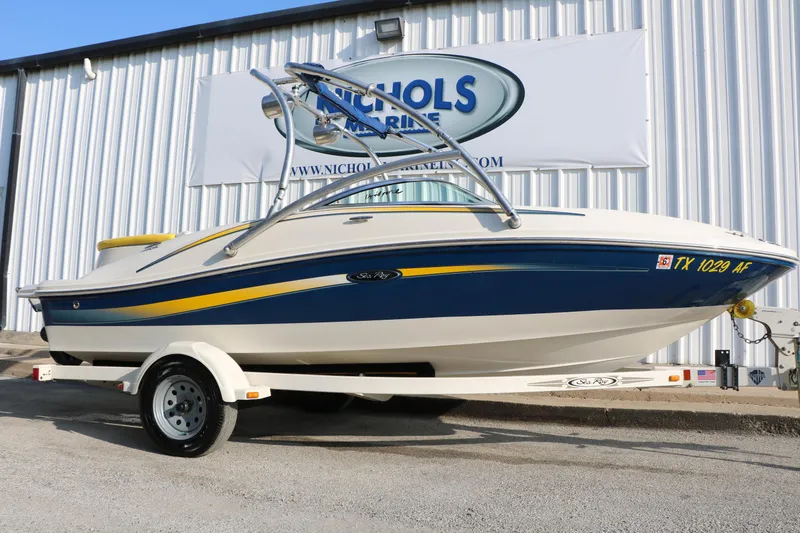 Slide: The Image of 2006 Sea Ray 185 Sport boat on trailer, parked outside Nichols Marine dealership. - 9