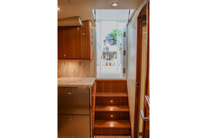Slide: The Image of Interior view of 2017 Viking 37 Billfish yacht with wooden cabinetry and stairs. - 14