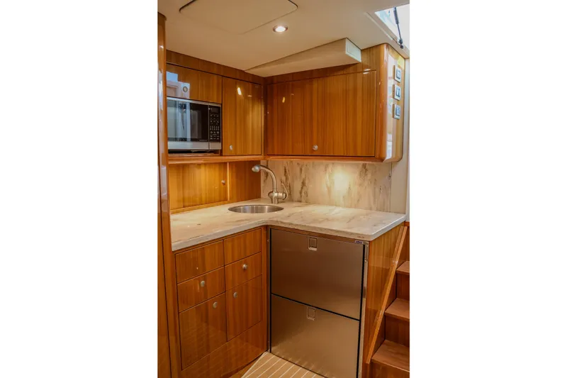 Slide: The Image of Luxurious galley in 2017 Viking 37 Billfish yacht with wood cabinetry and modern appliances. - 15