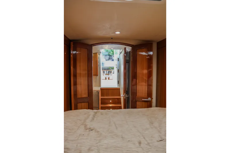 Slide: The Image of Interior view of 2017 Viking 37 Billfish yacht cabin with wooden doors and cozy bedding. - 18