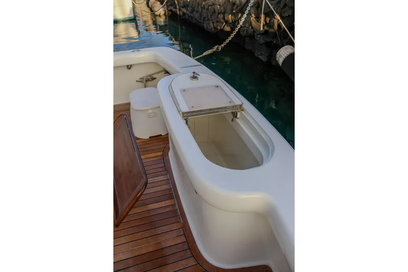 Slide: The Image of 2017 Viking 37 Billfish boat deck with storage compartment and wooden flooring. - 5