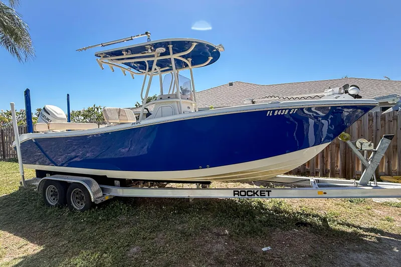 The Image of 2019 Sea Chaser 24 HFC boat on trailer, blue hull, parked outdoors. - 0