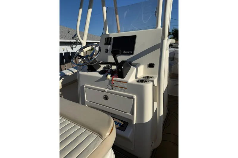 Slide: The Image of 2019 Sea Chaser 24 HFC boat console with steering wheel and navigation equipment. - 13