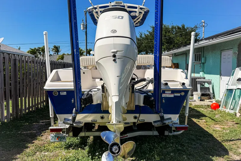 Slide: The Image of 2019 Sea Chaser 24 HFC boat with powerful outboard motor in a backyard setting. - 14