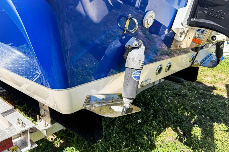 Slide: The Image of 2019 Sea Chaser 24 HFC boat stern with trim tab and blue hull. - 15