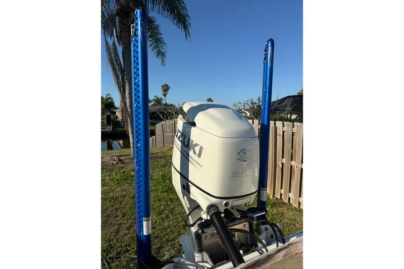 Slide: The Image of 2019 Sea Chaser 24 HFC with Suzuki 250 outboard motor, blue power poles, sunny day. - 9