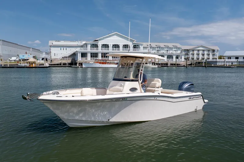 Slide: The Image of 2024 Grady-White Fisherman 236 boat docked near waterfront buildings. - 11