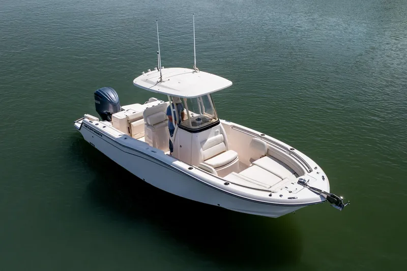 Slide: The Image of 2024 Grady-White Fisherman 236 boat on calm water, showcasing sleek design and spacious deck. - 13
