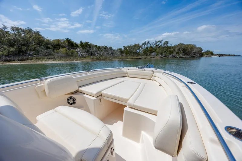 Slide: The Image of 2024 Grady-White Fisherman 236 boat interior with cushioned seating, scenic water view. - 17